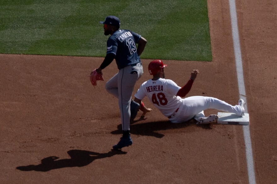 St. Louis Cardinals catcher Iván Herrera (#48) slides past Tampa Bay Rays infielder Junior Caminero (#13) and into third base during MLB Opening Day at Busch Stadium on Thursday, March 26, 2026, in downtown St. Louis.