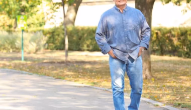 older man walking in a park