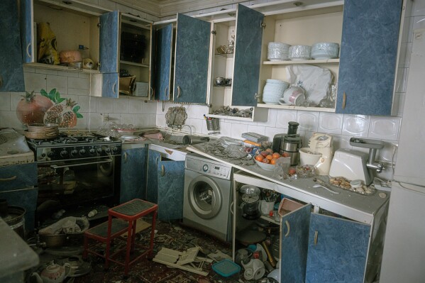 A damaged kitchen in a house affected when a nearby residential building was hit in an overnight strike during the U.S.-Israeli military campaign in Tabriz, East Azerbaijan Province, northwestern Iran, Tuesday, March 24, 2026. (AP Photo/Matin Hashemi)
