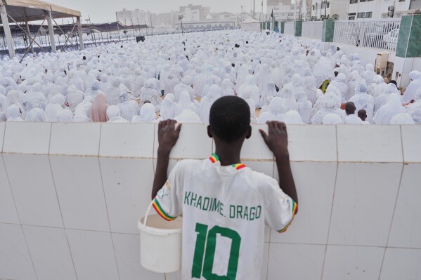 Muslims perform Eid al-Fitr prayers marking the end of the holy fasting month of Ramadan in Dakar, Senegal, Saturday, March 21, 2026. (AP Photo/Misper Apawu)