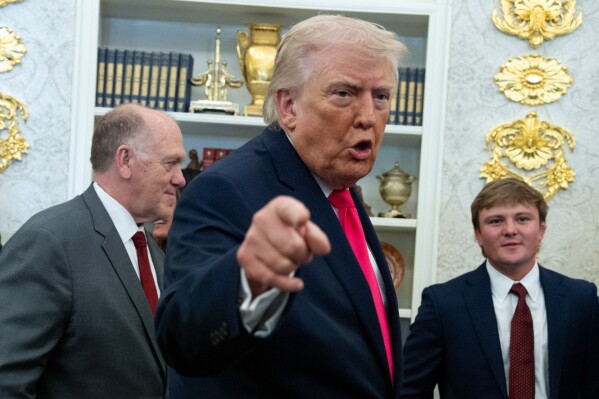 President Donald Trump speaks with reporters during the swearing in ceremony for Homeland Security Secretary Markwayne Mullin in the Oval Office of the White House, Tuesday, March 24, 2026, in Washington. (AP Photo/Alex Brandon)
