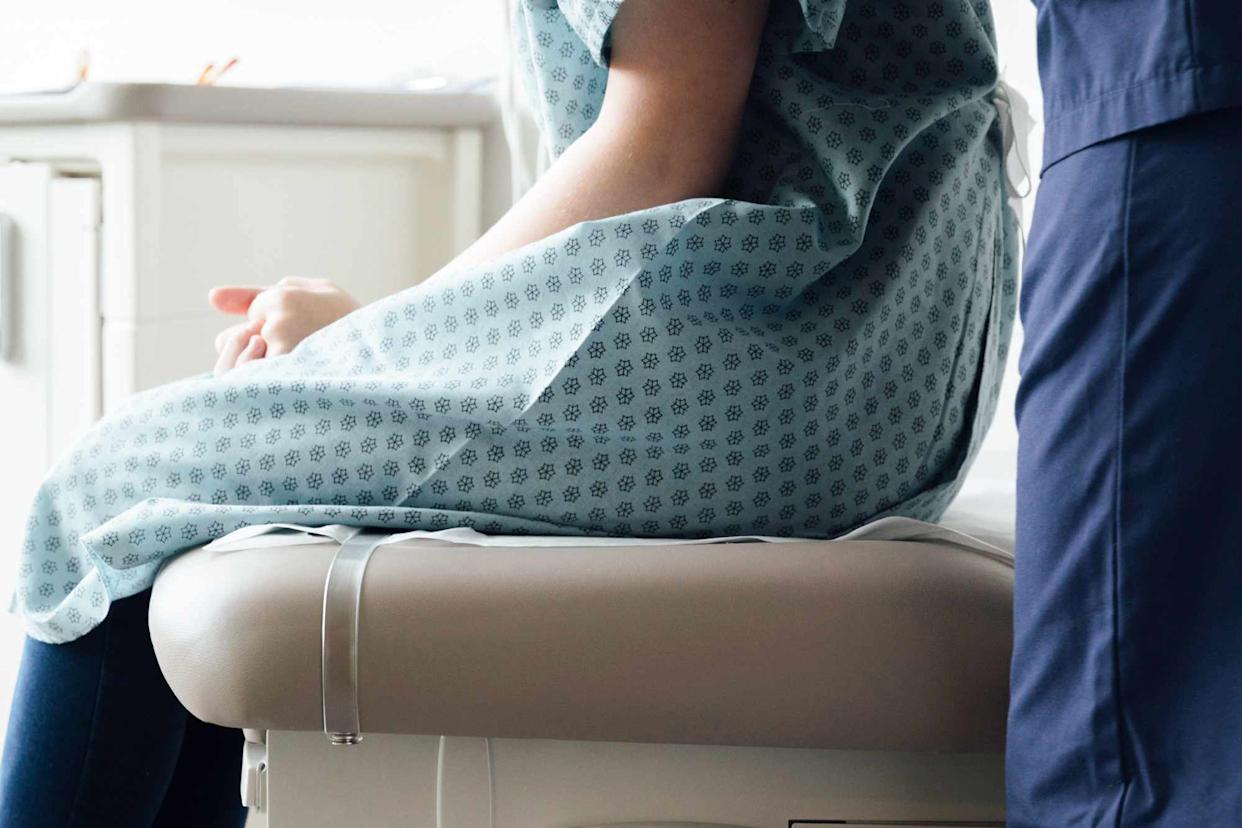Stock photo of woman sitting on exam table.Credit: Getty