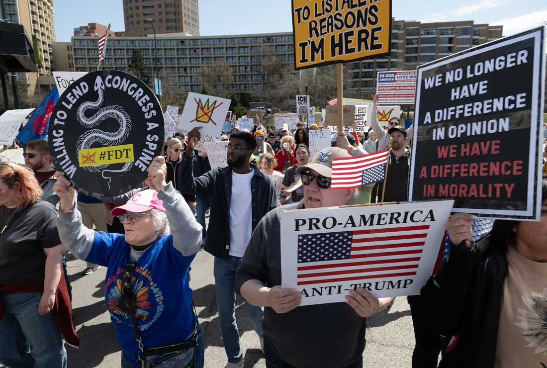 Crowds march through the Country Club Plaza in Kansas City, Mo., on Saturday to oppose the actions of the Trump administration.