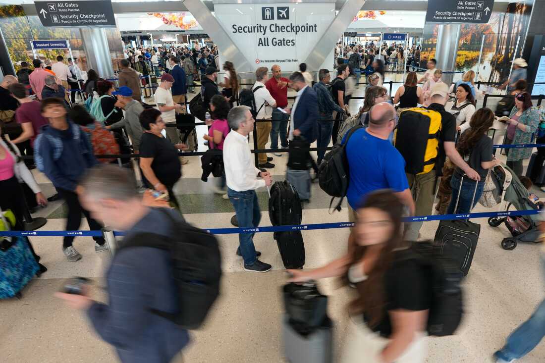 Travelers wait in long security checkpoint lines at George Bush Intercontinental Airport Friday, March 27, 2026, in Houston.