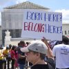 Jenny Harris, of Baltimore, protests in support of birthright citizenship and the immigrant community, May 15, 2025, outside of the Supreme Court in Washington.