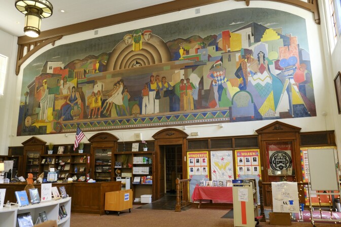 A colorful mural includes dancers, actors and a large bandshell.