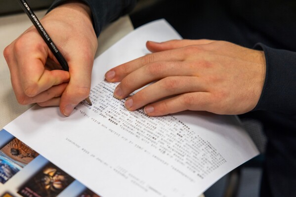 Marcello Popelka makes edits using a pencil after writing an assignment in German on a typewriter at Cornell University, Friday, March 20, 2026, in Ithaca, N.Y. The professor, Grit Matthias Phelps, brings out the typewriters once each semester for students to disconnect from technology and connect with the assignment in a different way. (AP Photo/Lauren Petracca)