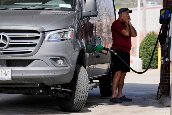 Ray Ruda fills his van with fuel at a gas station Wednesday, March 25, 2026, in Brentwood, Tenn. (AP Photo/George Walker IV)