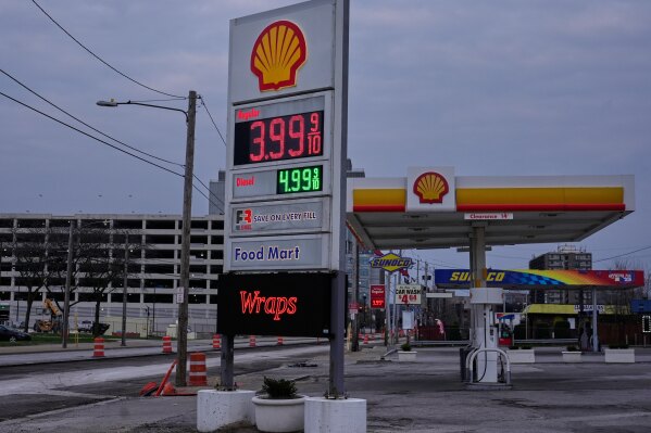 Two gas stations display signs for $3.999 for regular gasoline, in Cleveland, Monday, March 30, 2026. (AP Photo/Sue Ogrocki)
