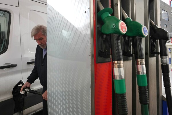 A man fills his car with diesel at a gas station in London, Monday, March 30, 2026. (AP Photo/Kin Cheung)