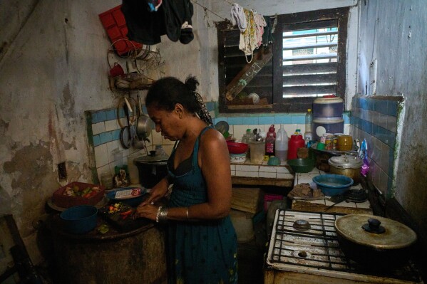 Yuneisy Riviaux prepares dinner in her kitchen in Havana, Cuba, Wednesday, March 25, 2026. (AP Photo/Ramon Espinosa)