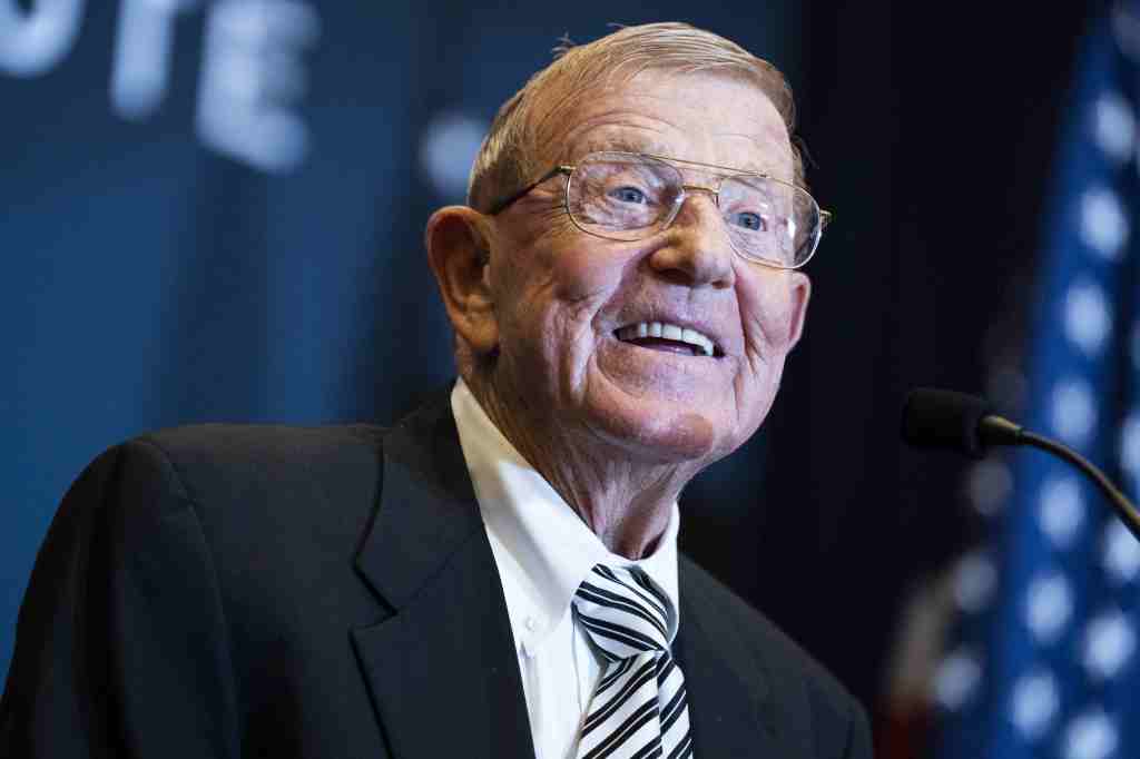Lou Holtz smiling while addressing the America First Policy Institute's America First Agenda Summit.