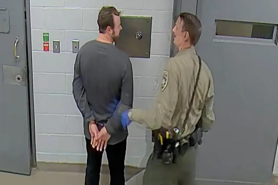 Joseph Duggar jokes with a member of law enforcement while being booked into custody on March 18Credit: Washington County Sheriff's Office via AP