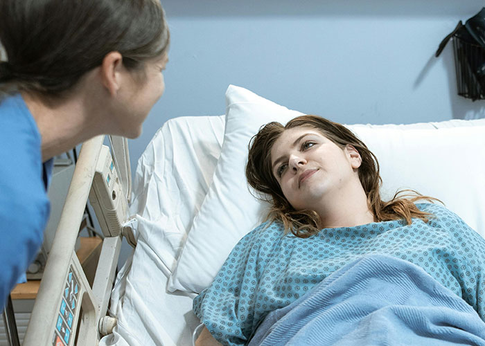 Patient in hospital bed talking to nurse, highlighting medical secrets and concerns about healthcare experiences.