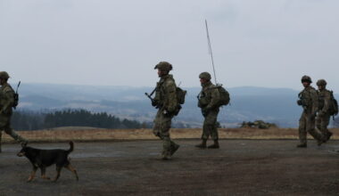 U.S. Army soldiers from the 82nd Airborne Division walk towards an airbase, near Arlamow