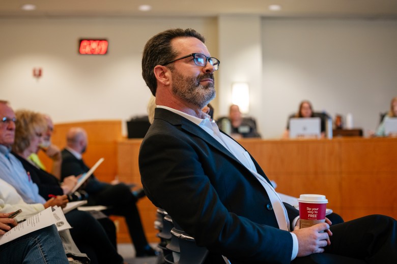 Dr. Remington Nevin, Medical Director of St. Clair County's Health Department, sits in the front row of the the St. Clair County Board of Commissioners monthly meeting. Among other topics, residents and dental professionals have shown up to oppose Dr. Nevin's plan to remove fluoride from the county's drinking water.