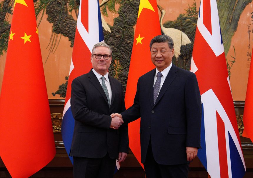Britain's Prime Minister Keir Starmer shakes hands with Chinese President Xi Jinping ahead of a bilateral meeting during his visit to China, in Beijing on January 29, 2026.