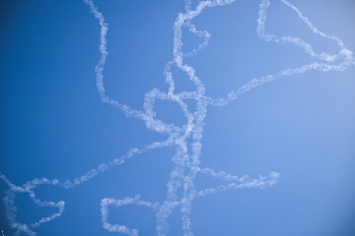 Vapor trails remain in the sky above Tel Aviv, Israel, after Israel intercepted missiles launched from Iran on Friday, March 6.