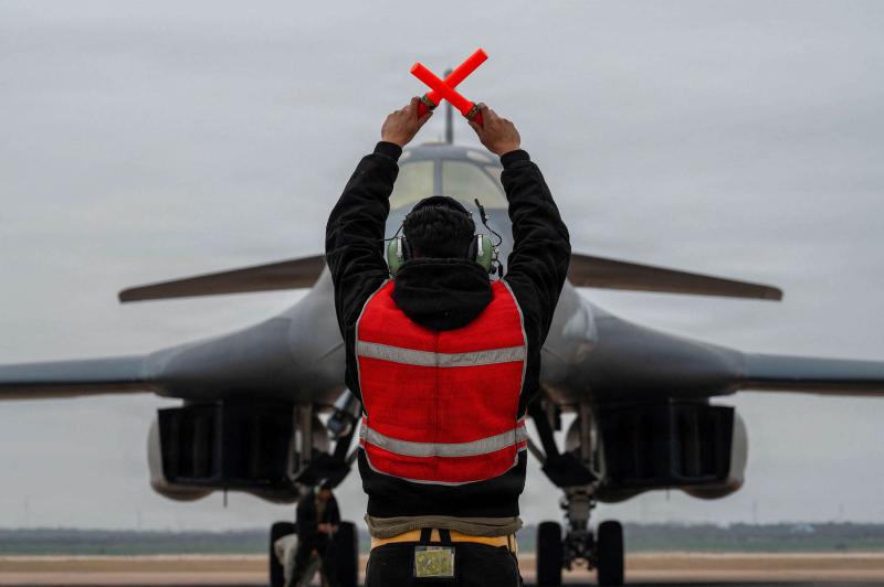 A US Air Force B-1B Lancer bomber is marshalled by a crew chief after returning from a mission in support of the Operation Epic Fury attack on Iran to an undisclosed location in the United States.