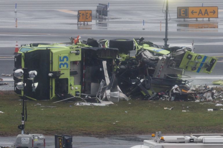 A damaged fire truck at the scene after an Air Canada Express jet collided with a ground vehicle at New York's LaGuardia Airport in Queens