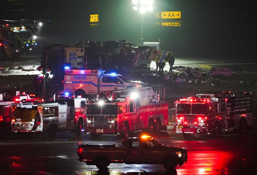 Emergency crews respond to a collision between a vehicle and an Air Canada Express jet at New York's LaGuardia Airport.
