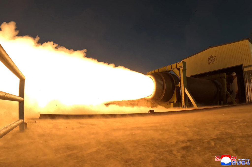 North Korea's Kim Jong Un observes a ground ejection test of a high-output solid-fuel engine using carbon fiber composite ...