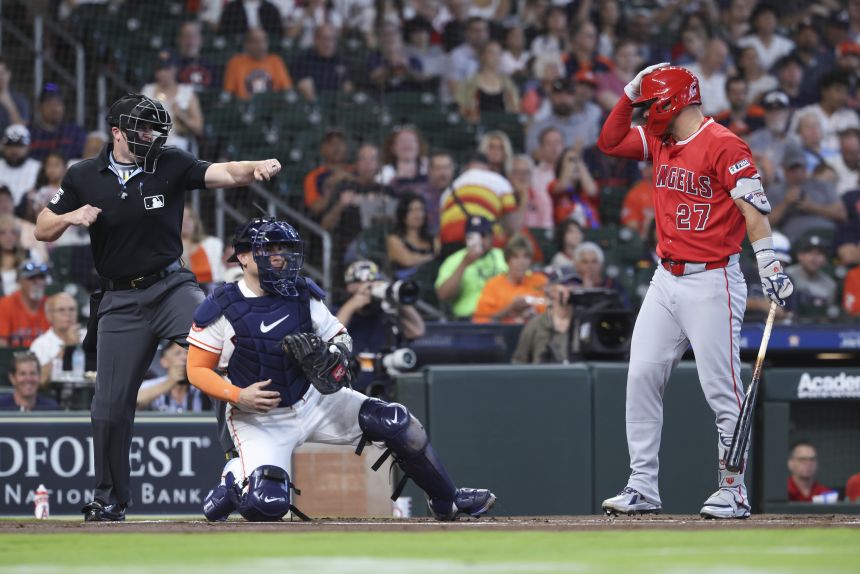 Los Angeles Angels slugger Mike Trout taps his helmet, calling for an ABS challenge in Houston on Sunday.