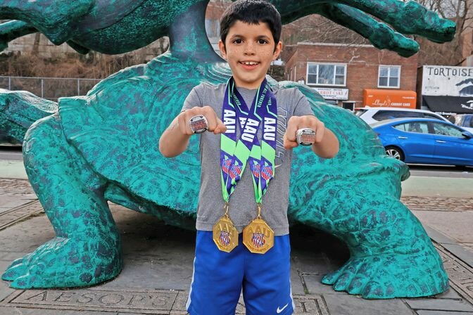 Joah Henry left the Amateur Athletic Union Indoor National Championship with two gold medals and two trophy rings.