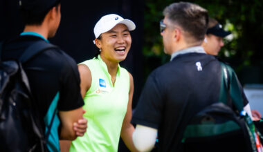 Janice Tjen laughs with her coaches on the sidelines of the Dubai Duty Free Tennis Championships in Dubai, United Arab Emirates, on Feb. 18, 2026.