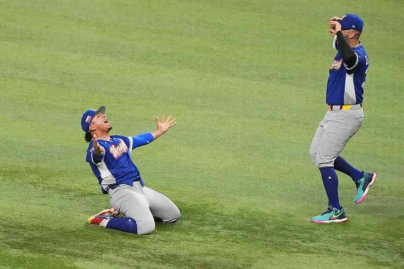 Venezuela pitcher Daniel Palencia, left, celebrates after the team defeated the United States in the championship game of the World Baseball Classic, Tuesday, March 17, 2026, in Miami. (AP Photo/Lynne Sladky)