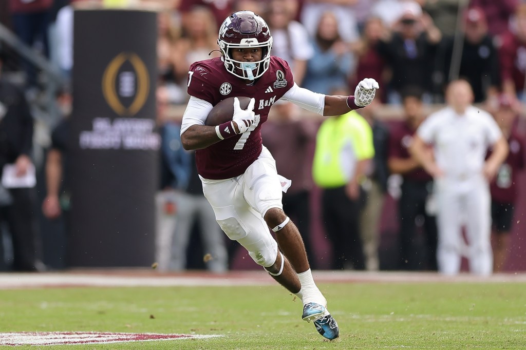 Texas A&M player wearing jersey number 7 running with the ball during the 2025 College Football Playoff First Round Game.