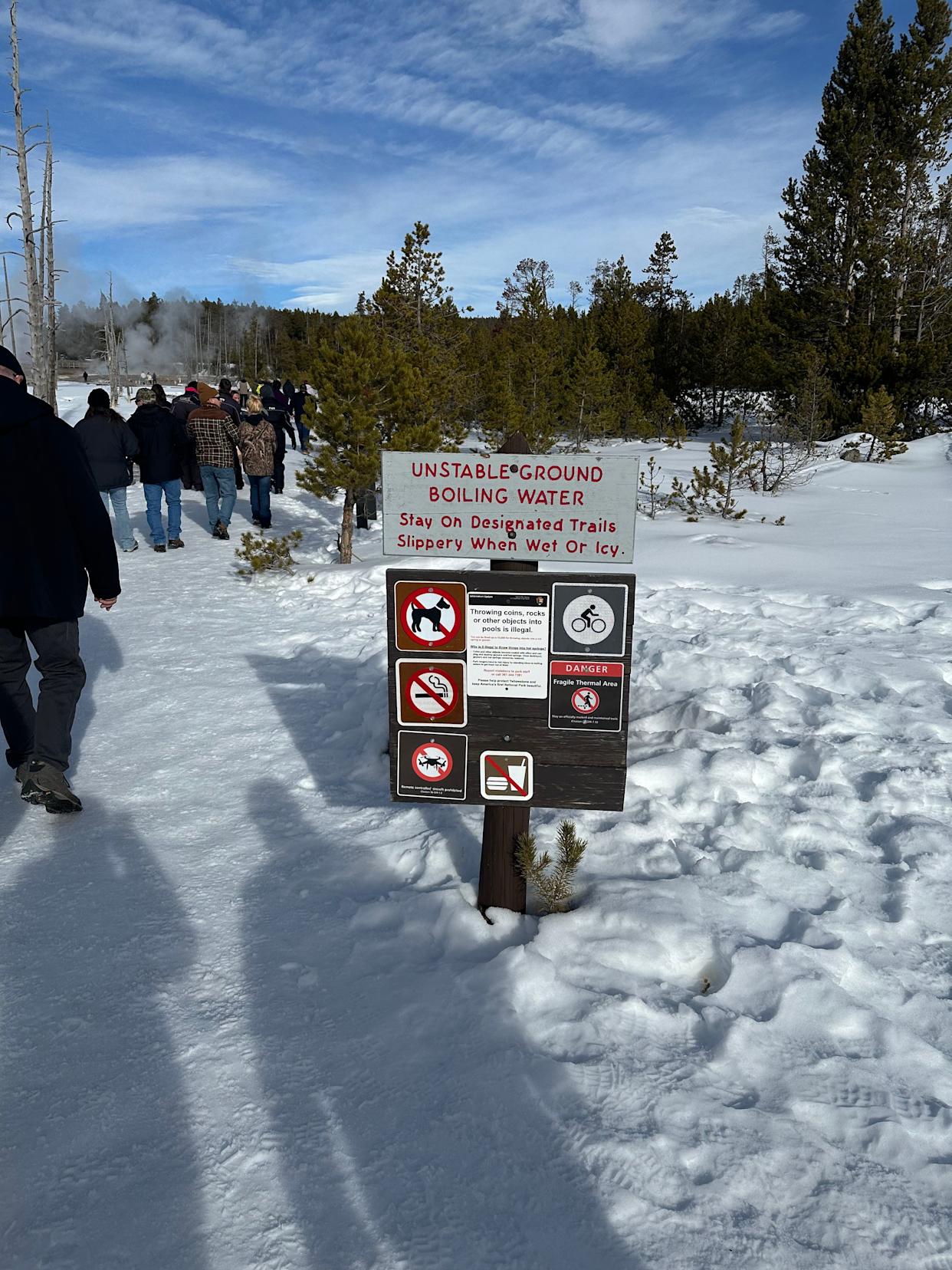Signs warn visitors to stay on marked paths throughout Yellowstone National Park.