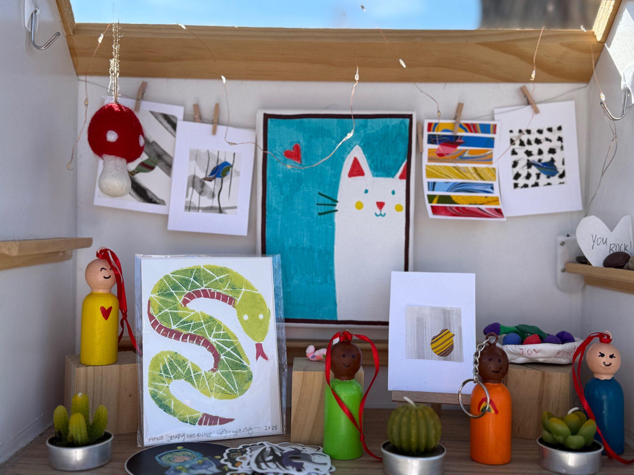 A small art gallery with brightly colored illustrations and dolls.