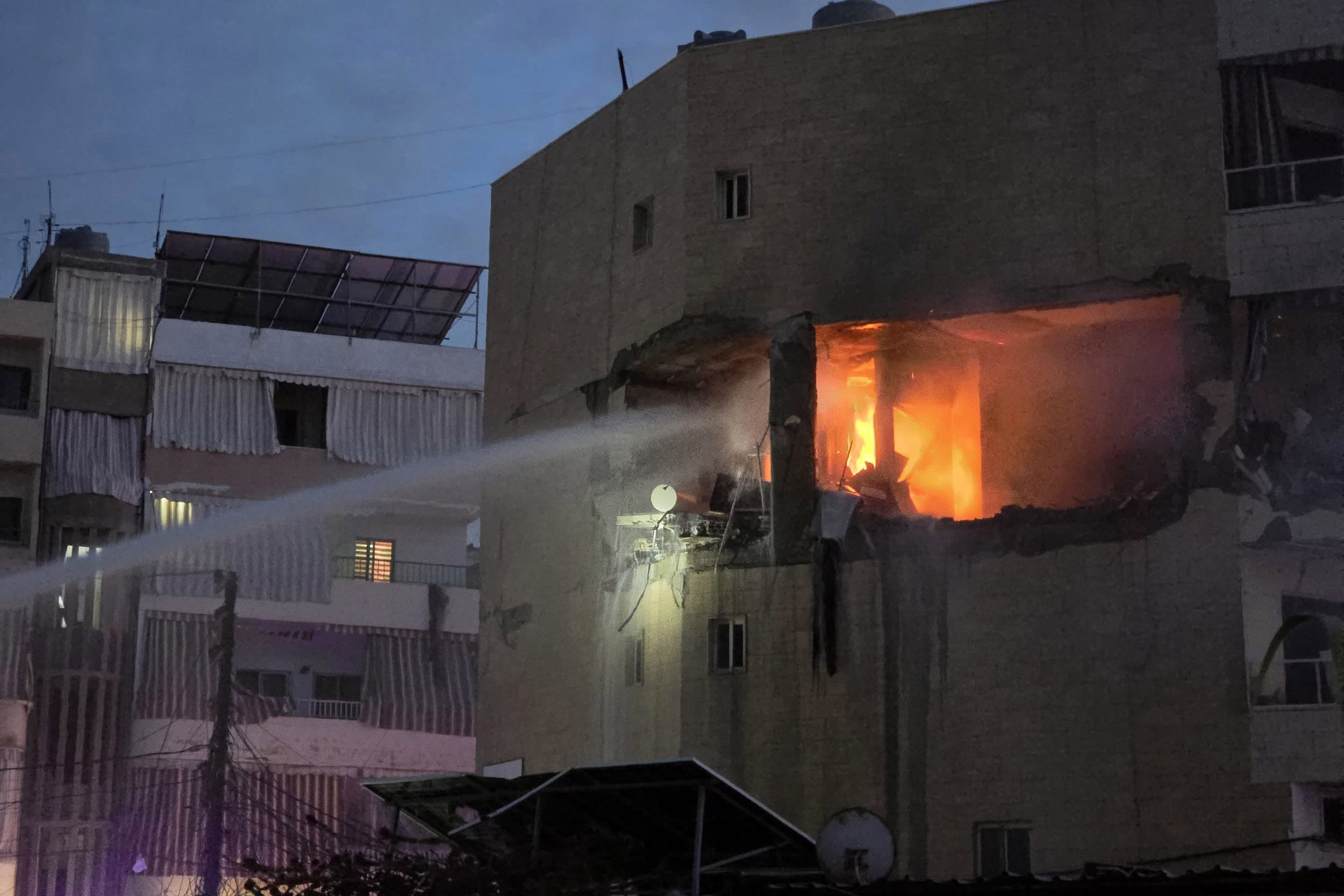 Fire erupts in a building targeted by an Israeli airstrike in the southern Lebanese coastal city of Tyre on March 11, 2026.