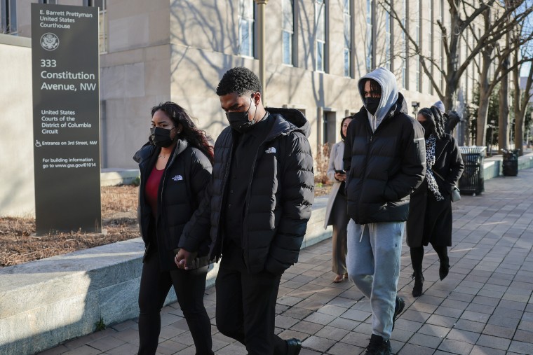 Brian Cole Jr.'s family exit the E. Barrett Prettyman Courthouse 