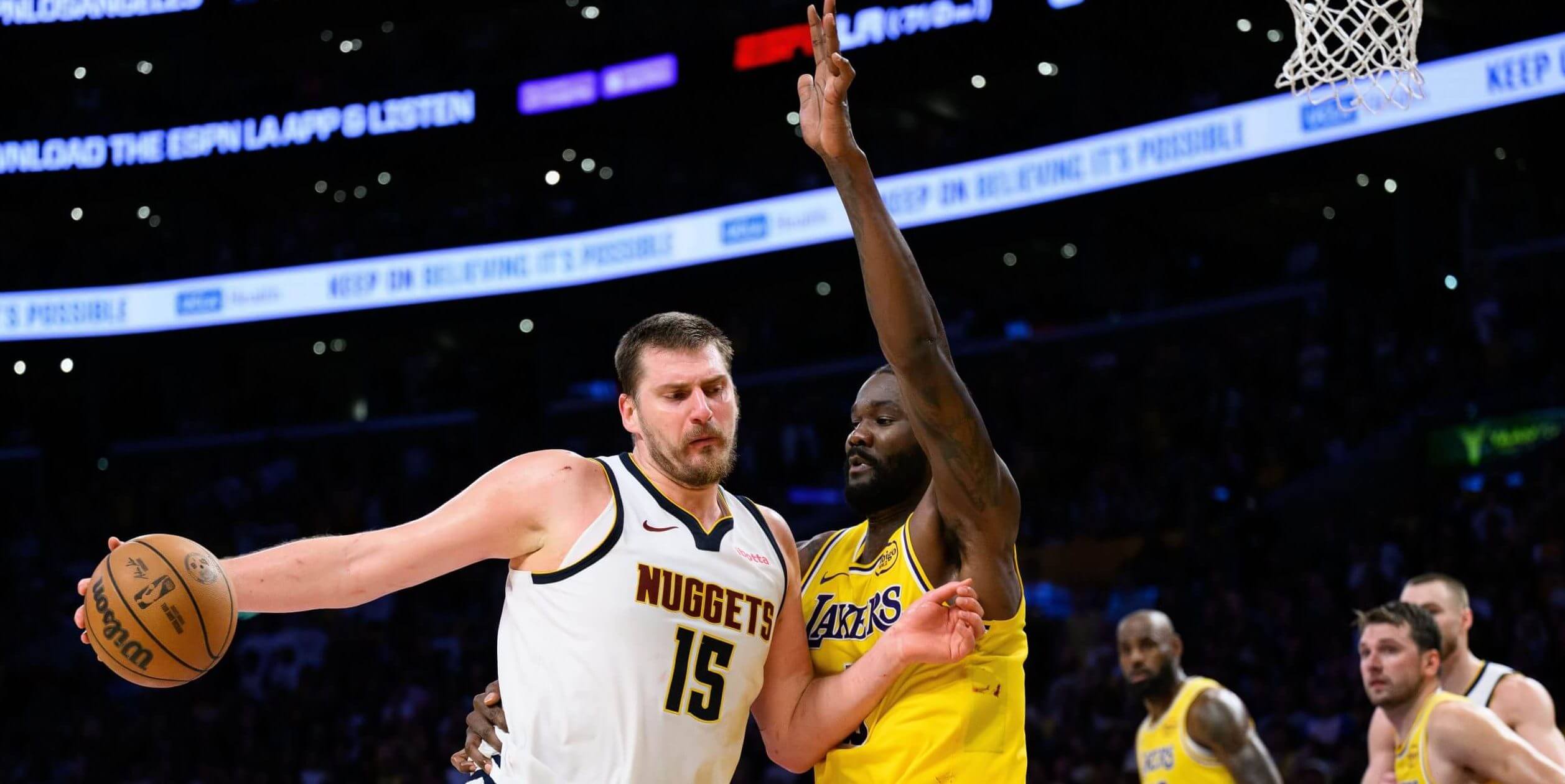 Denver's Nikola Jokic drives on Los Angeles' Deandre Ayton.