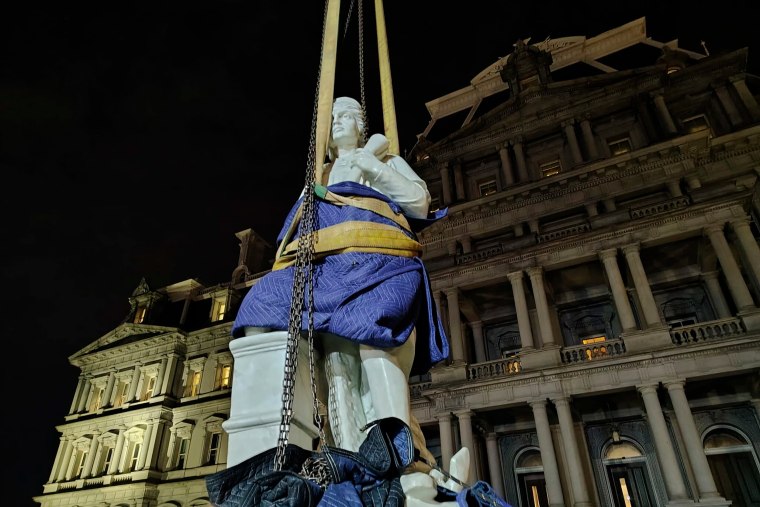 The statue being installed in front of the Eisenhower Executive Office Building on Sunday.