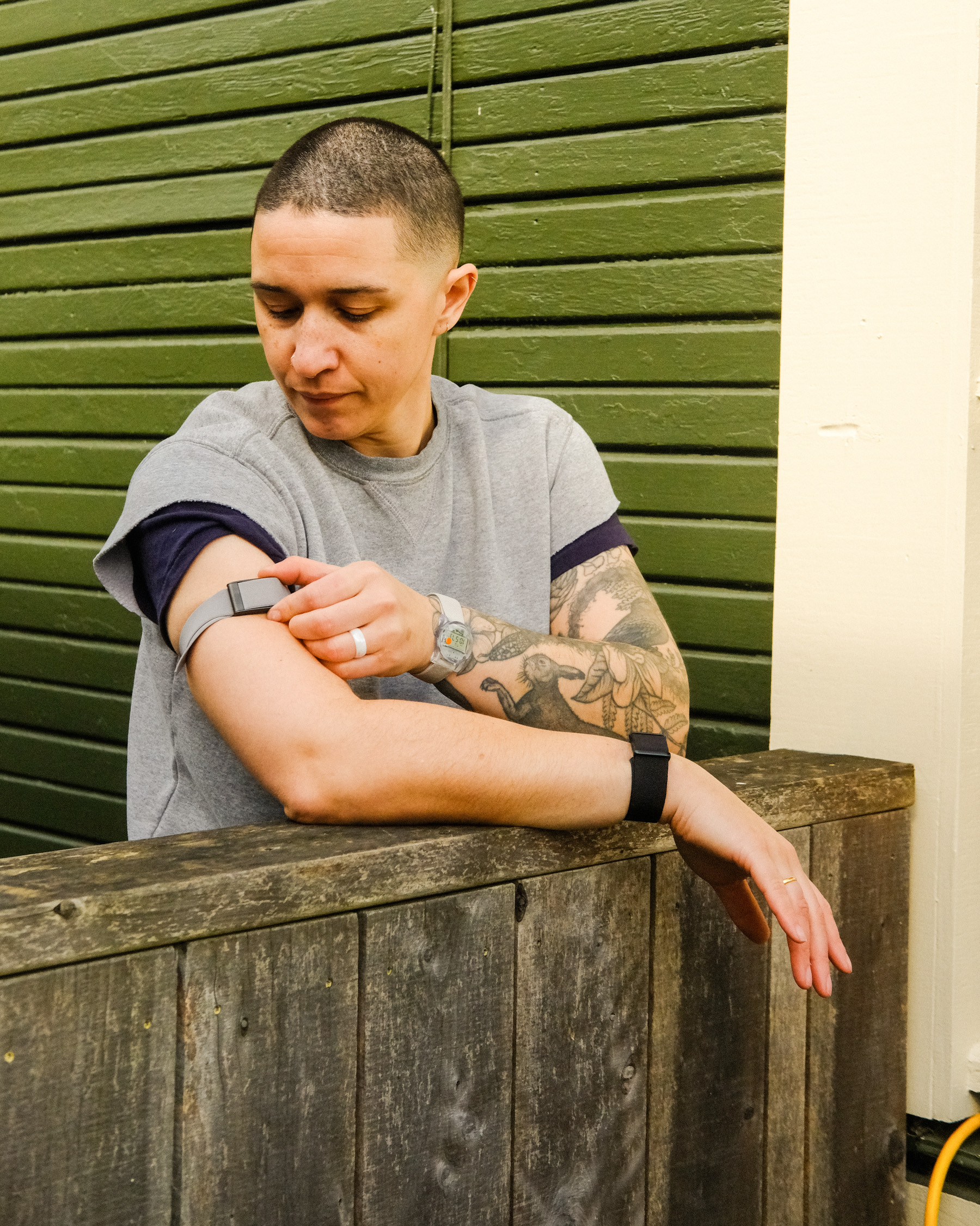 Arielle Duhaime-Ross checks their Whoop arm band.