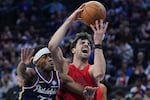 Portland Trail Blazers' Deni Avdija, right, goes up to shoot against Philadelphia 76ers' Vj Edgecombe during the first half of an NBA basketball game Sunday, March 15, 2026, in Philadelphia.