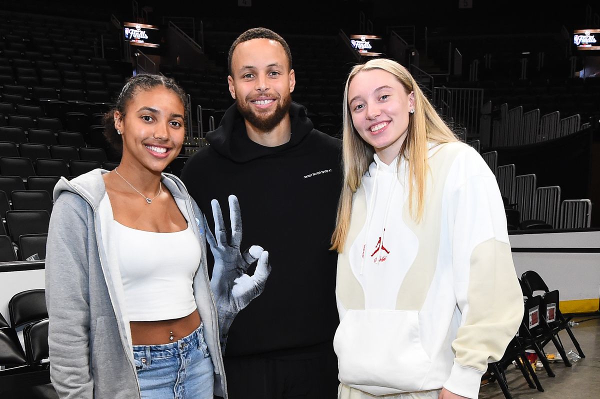 Stephen Curry #30 of the Golden State Warriors poses for a photograph with UCONN players, Paige Bueckers and Azzi Fudd after Game Four of the 2022 NBA Finals on June 10, 2022 at TD Garden in Boston, Massachusetts.