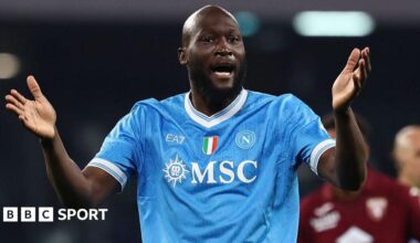 Romelu Lukaku in Napoli's light blue shirt, with raised arms held out in front of him