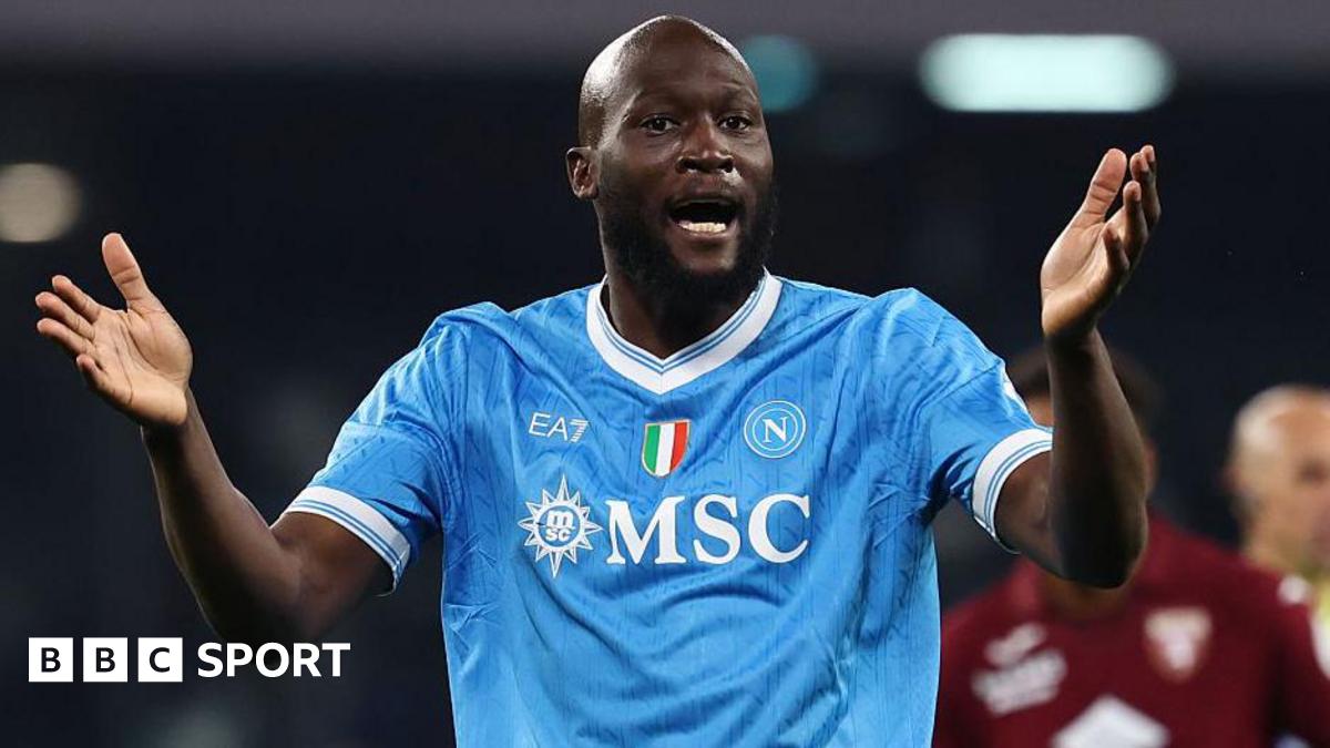 Romelu Lukaku in Napoli's light blue shirt, with raised arms held out in front of him