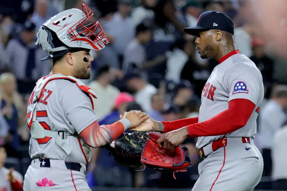 Sep 30, 2025; Bronx, New York, USA. Boston Red Sox catcher Carlos Narvaez (75) and relief pitcher Aroldis Chapman (44) celebrate after defeating the New York Yankees in game one of the Wildcard round of the 2025 MLB playoffs at Yankee Stadium. Mandatory Credit: Brad Penner-Imagn Images