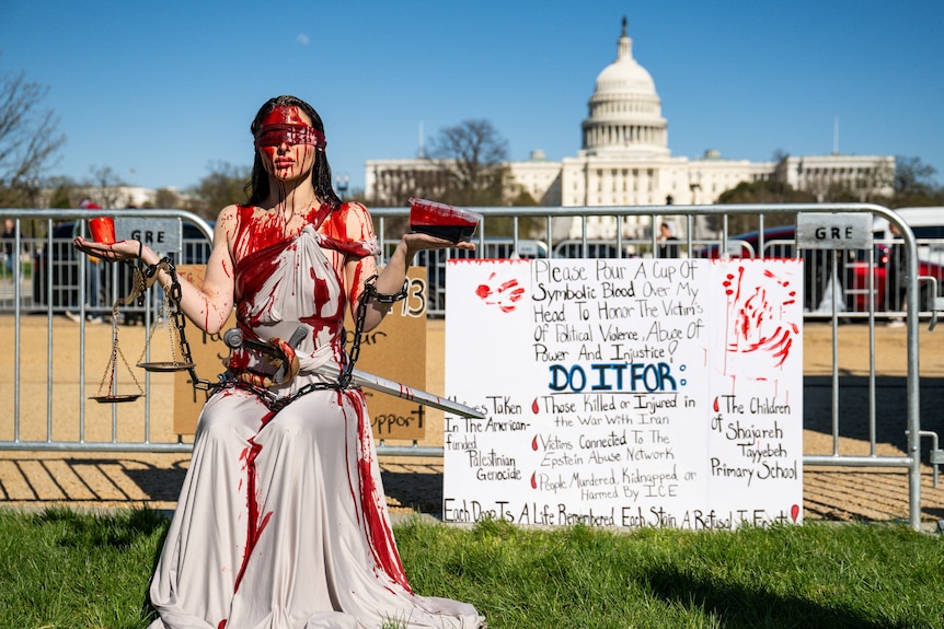 A demonstrator asking for others to pour "blood" over her in support of "victims of political violence".