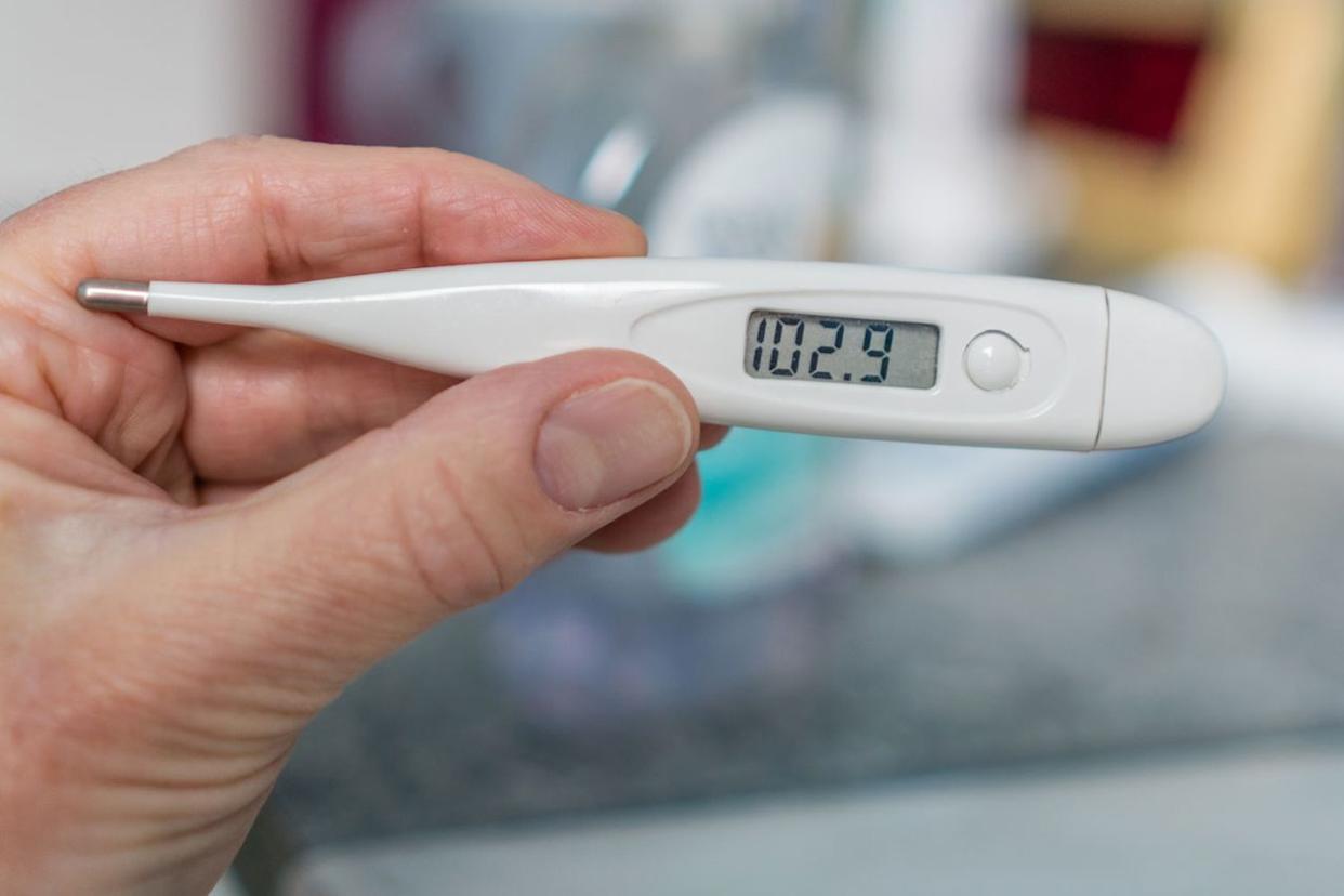 Stock image of a thermometer showing a high feverCredit: Getty