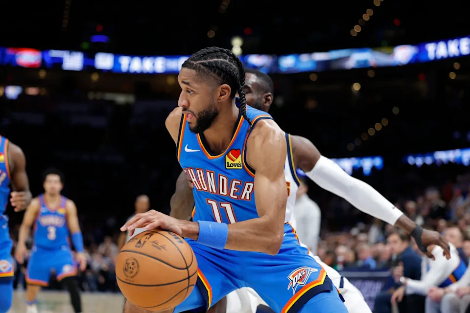 Mar 9, 2026; Oklahoma City, Oklahoma, USA; Oklahoma City Thunder guard Isaiah Joe (11) drives around Denver Nuggets guard/forward Tim Hardaway Jr. (10) during the second half at Paycom Center. Mandatory Credit: Alonzo Adams-Imagn Images