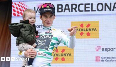 Jonas Vingegaard holds his young son on the podium after his victory