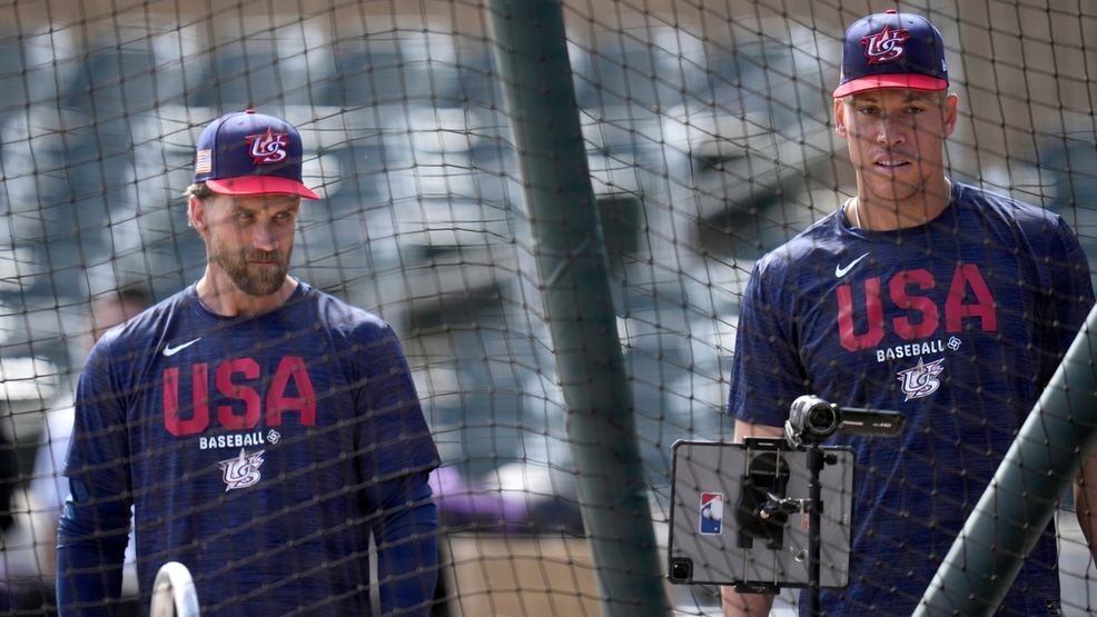 United States' Bryce Harper, left, and Aaron Judge wait their turn during batting practice prior to an exhibition baseball game against the Colorado Rockies Wednesday, March 4, 2026, in Scottsdale, Ariz. (AP Photo/Ross D. Franklin)