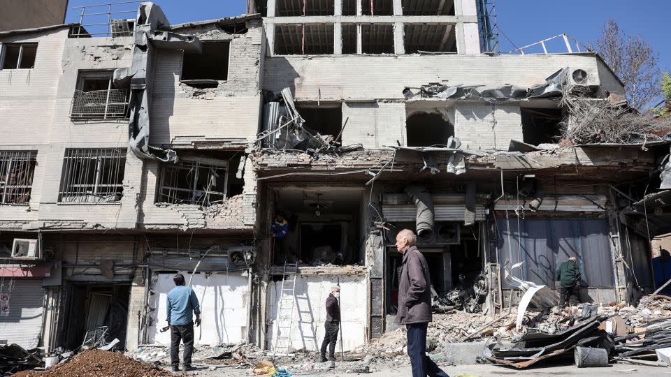 A man walks past a destroyed building following airstrikes in central Tehran, Iran, on March 4, 2026. - AFP/Getty Images