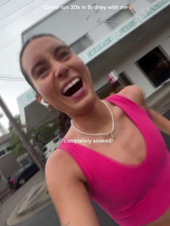 a woman running in a pink shirt